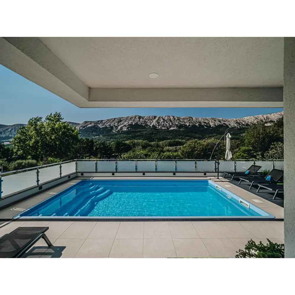 Glasfiberpool Aruba 800 med rektangulär form, klarblått vatten och grå kaklad kant