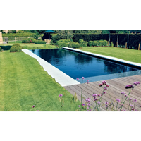 Lång rektangulär infinitypool Leisurepools Cube med mörkblått vatten och vita betongkanter