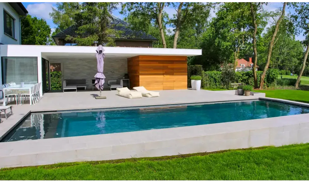 Modern Leisurepools Cube utomhuspool med rektangulär form, klart blått vatten och ljusa grå stenkanter