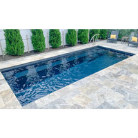 Leisurepools Harmony pool med djupblått vatten och grå stenplattor