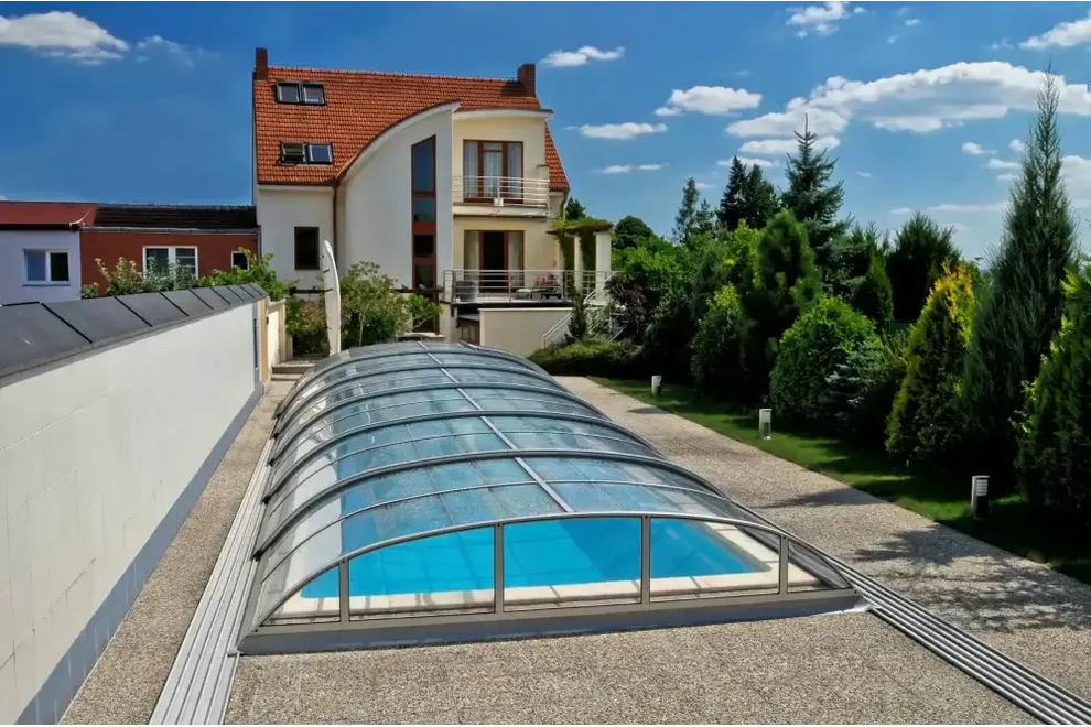 Pooltak Dallas med svart ram över blå pool med glas tak